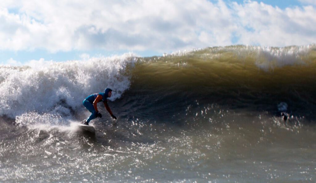 Surfer riding a wave in lake erie - unique things to do in pa