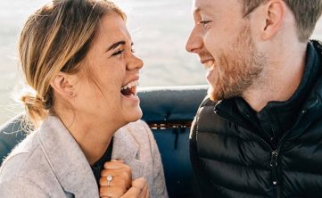 A couple laughing while taking a private balloon ride to Chester County and Philadelphia thanks to Lancaster Balloon Rides.